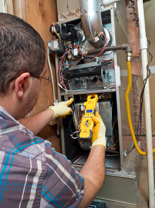 Repairman conducting residential HVAC repair