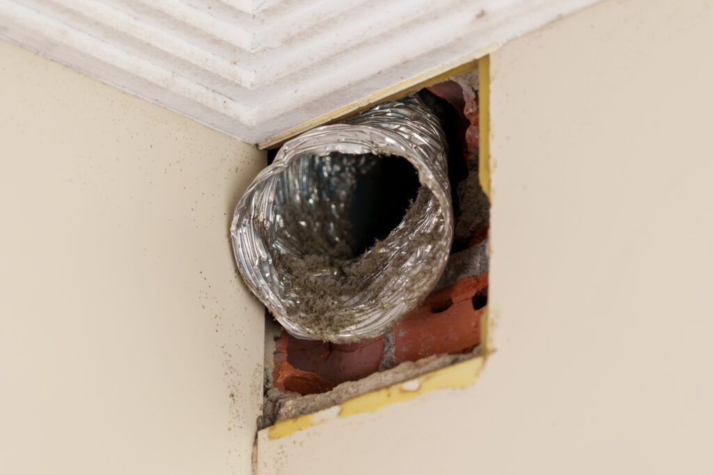 Old flexible aluminum ventilation duct with dust close up