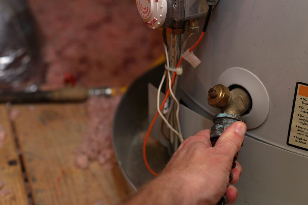 Plumber servicing water heater
