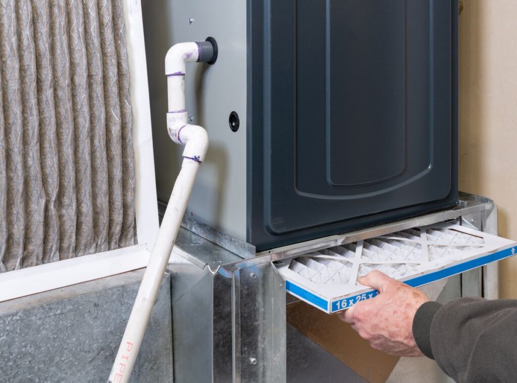 HVAC technician changing furnace filter