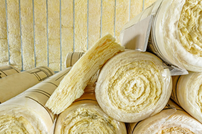 Stack of thermal insulation material in roll is wrapped with cellophane foil