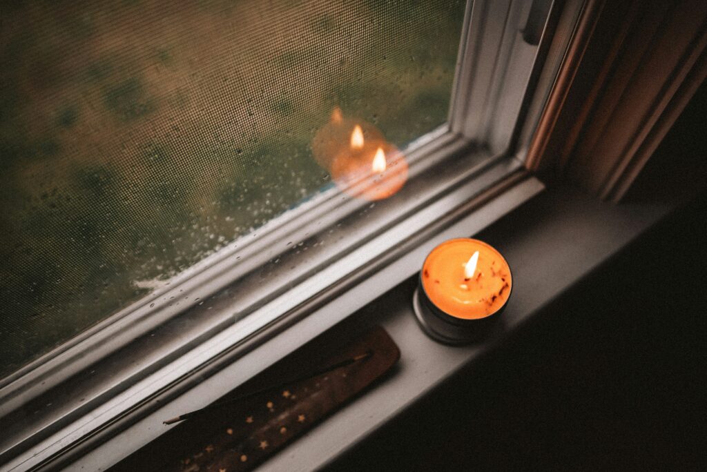 Candle & incense on a window sill