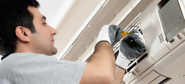 Technician performing a repair service on a ductless mini-split